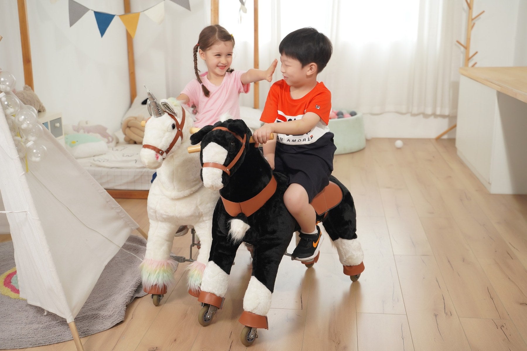 Children with real white and black ZEROOXRIDE ride-on toys indoors